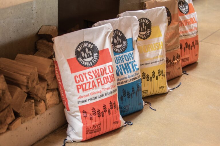Bags of specialty flours made by Matthews Cotswold flour arranged on the floor